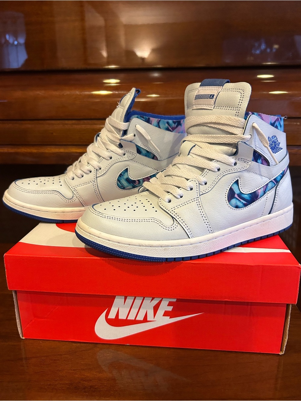Nike Air Jordan Men’s White High-Top Sneakers with Blue Marble Swoosh